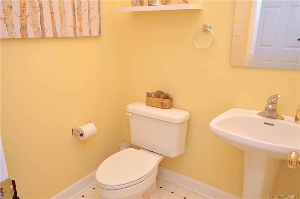 303 Spring Lake Road Maggie Valley, NC 28751 - Photo 14 of 25 a bathroom with a toilet sink and mirror