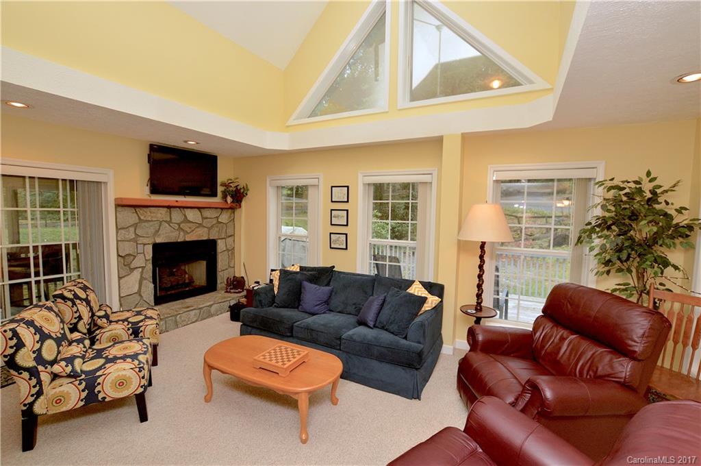 303 Spring Lake Road Maggie Valley, NC 28751 - Photo 3 of 25 a living room with furniture and a fireplace