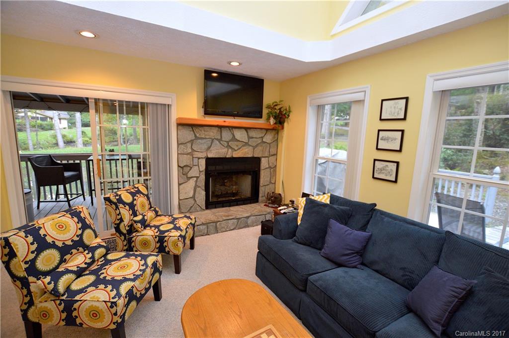 303 Spring Lake Road Maggie Valley, NC 28751 - Photo 7 of 25 a living room with furniture fireplace and flat screen tv