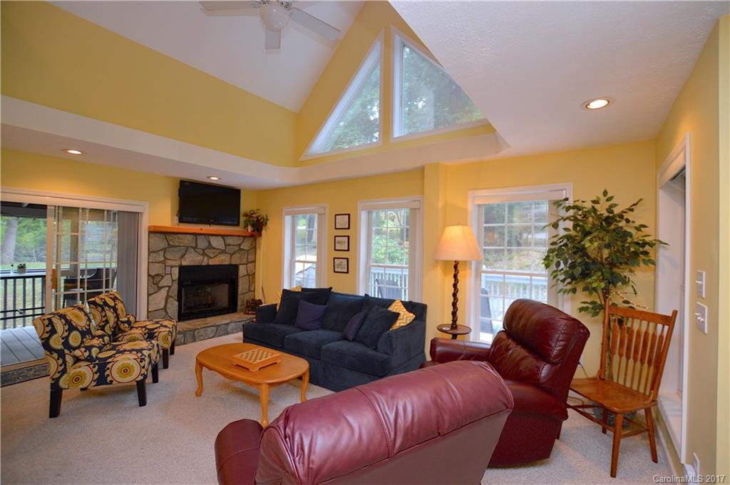 303 Spring Lake Road Maggie Valley, NC 28751 - Photo 8 of 25 a living room with furniture a fireplace and a potted plant