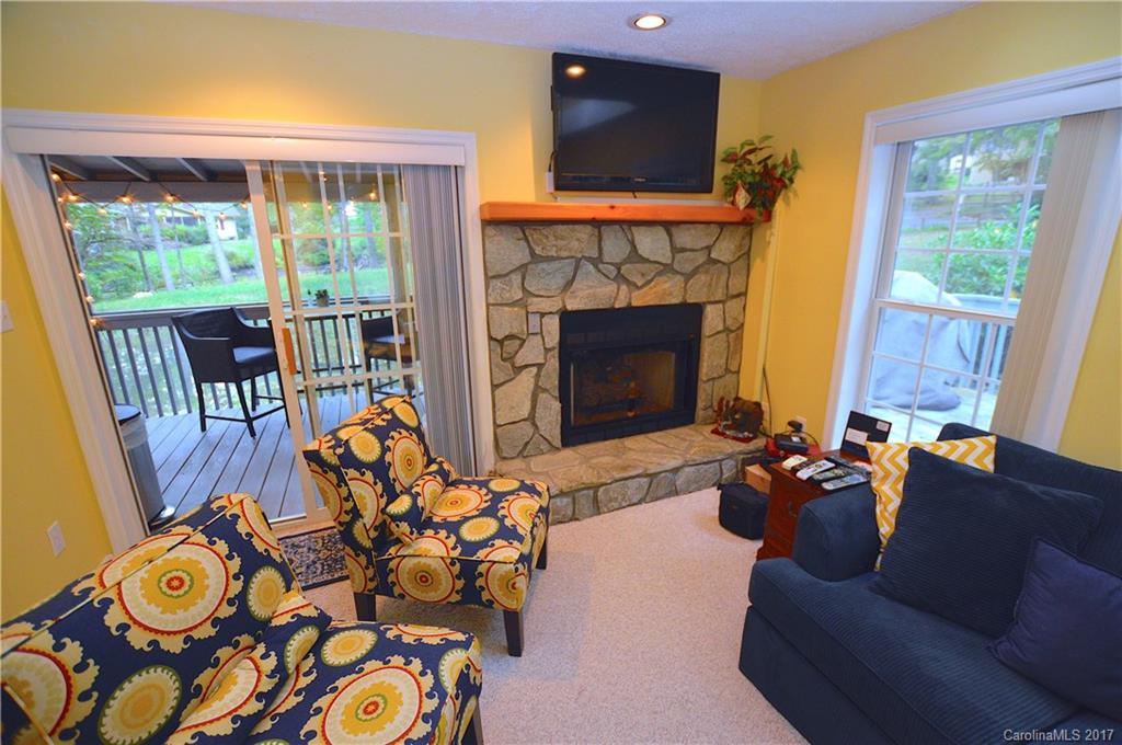 303 Spring Lake Road Maggie Valley, NC 28751 - Photo 9 of 25 a living room with furniture fireplace and flat screen tv