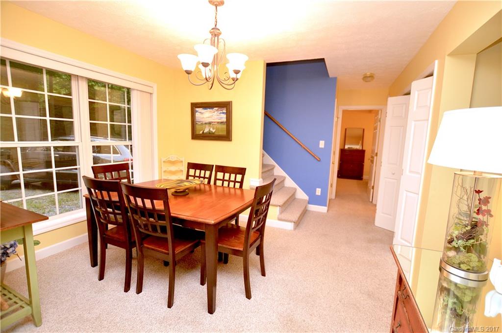 303 Spring Lake Road Maggie Valley, NC 28751 - Photo 10 of 25 a view of a dining room with furniture and a chandelier