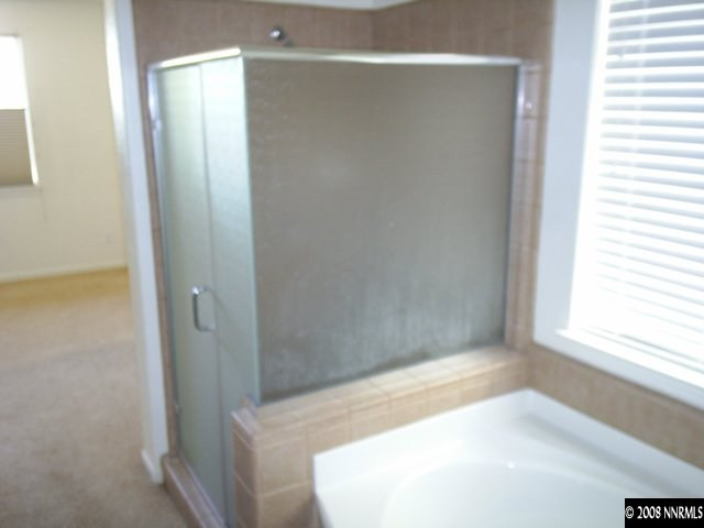 10653 Fire Poppy Circle Reno, NV 89521 - Photo 6 of 9 a bathroom with a bathtub