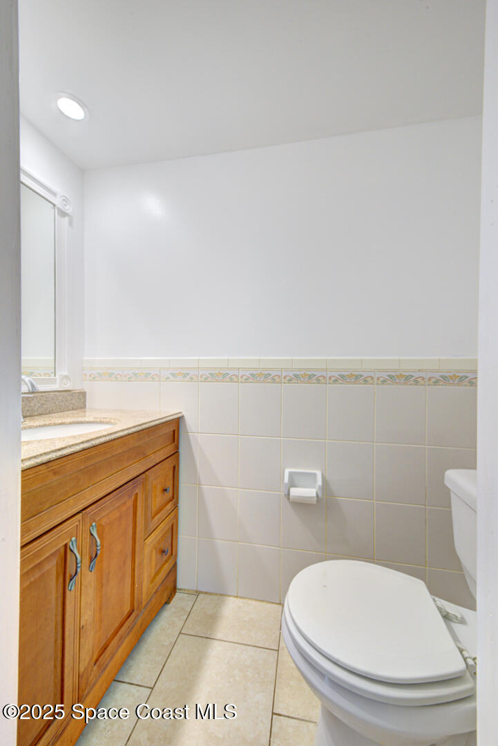 949 Brunswick Lane Rockledge, FL 32955 - Photo 12 of 43 a bathroom with a toilet a sink and mirror