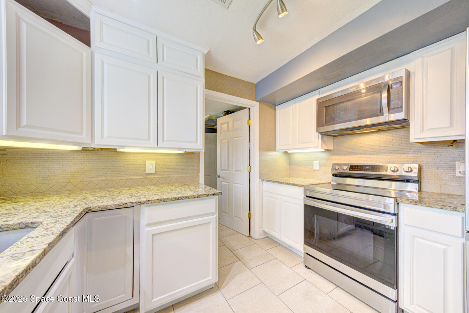 949 Brunswick Lane Rockledge, FL 32955 - Photo 17 of 43 a kitchen with granite countertop cabinets stainless steel appliances and a counter space