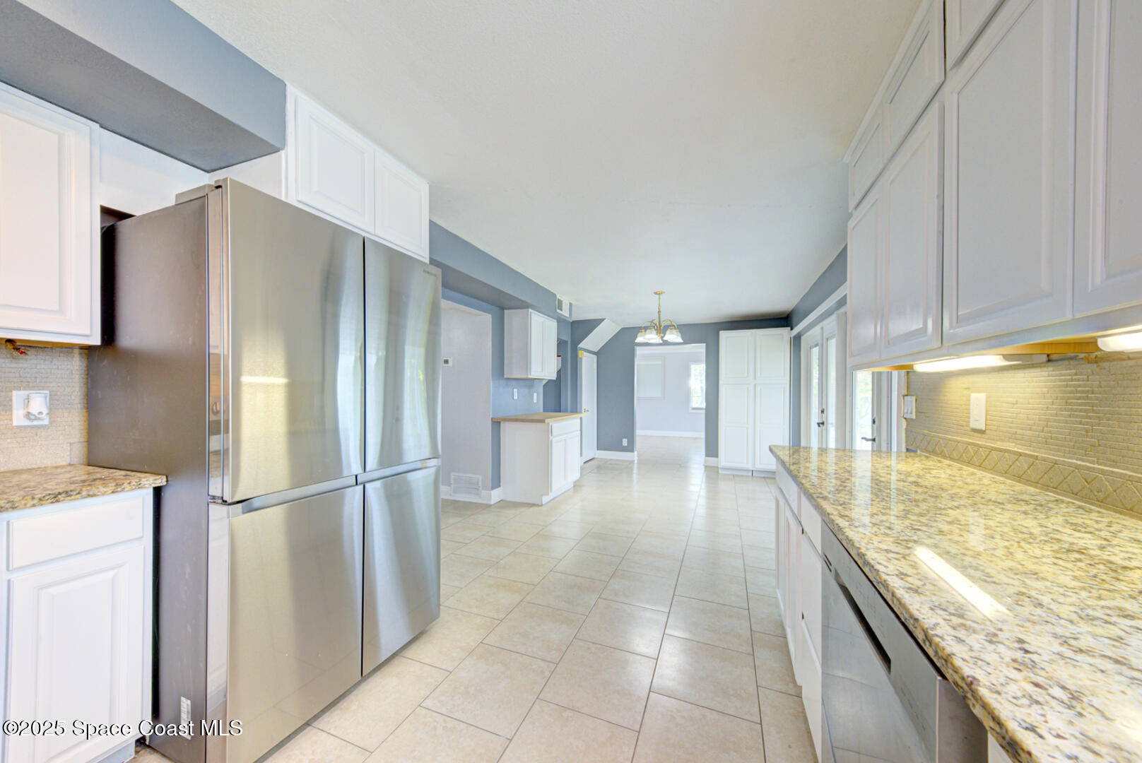 949 Brunswick Lane Rockledge, FL 32955 - Photo 18 of 43 a view of a kitchen with a sink and a refrigerator