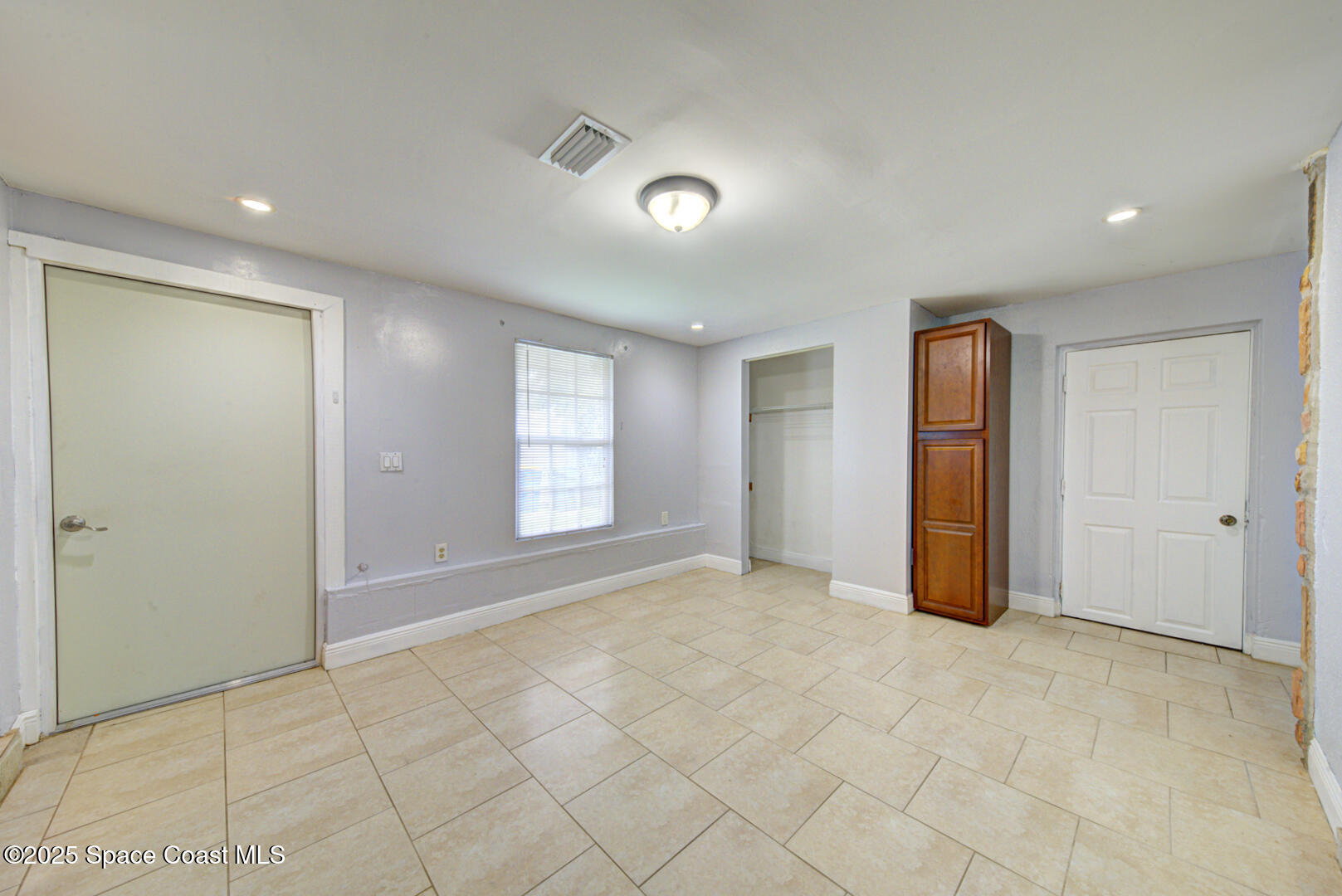 949 Brunswick Lane Rockledge, FL 32955 - Photo 21 of 43 an empty room with windows and closet