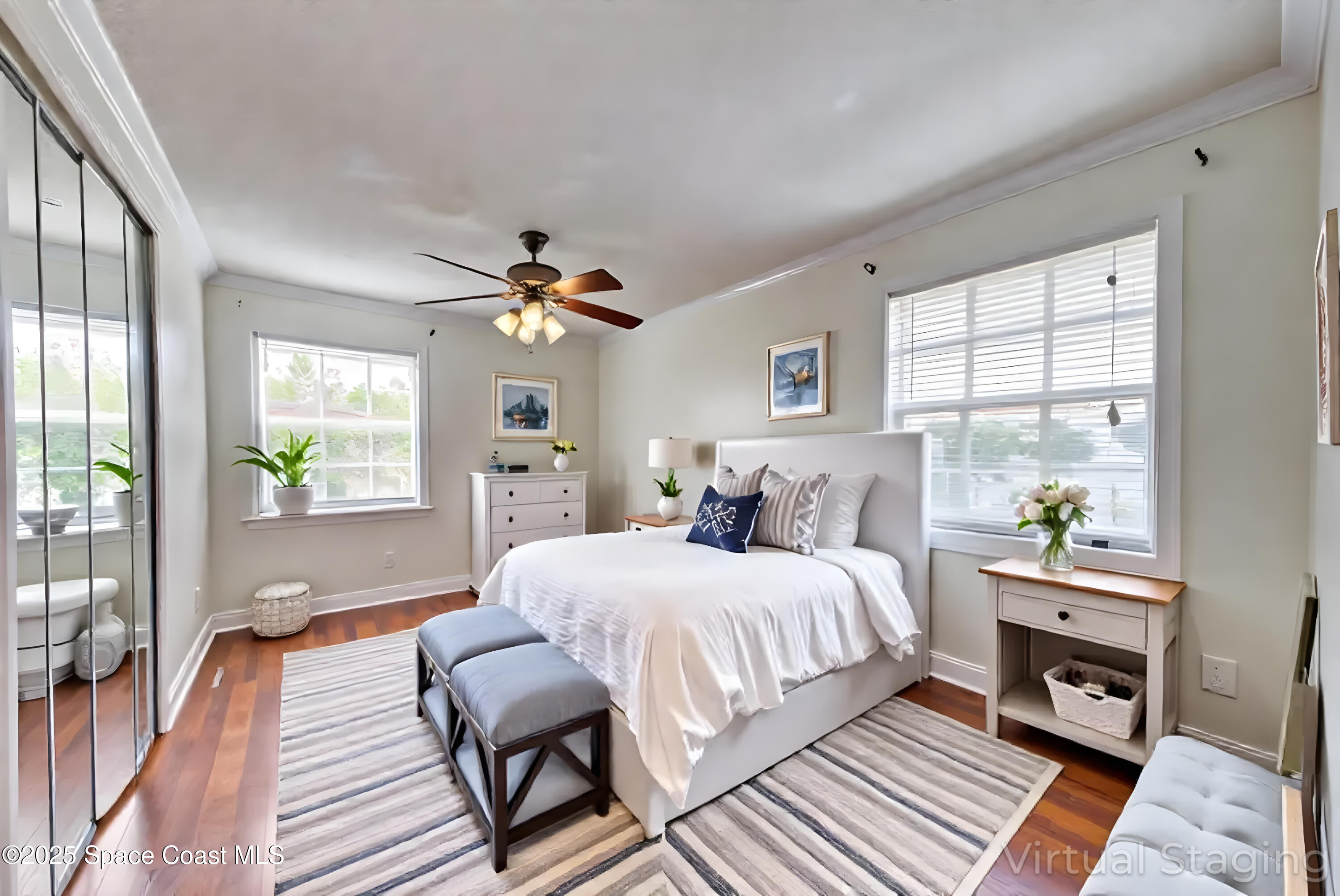 949 Brunswick Lane Rockledge, FL 32955 - Photo 25 of 43 a bedroom with a bed wooden floor and windows