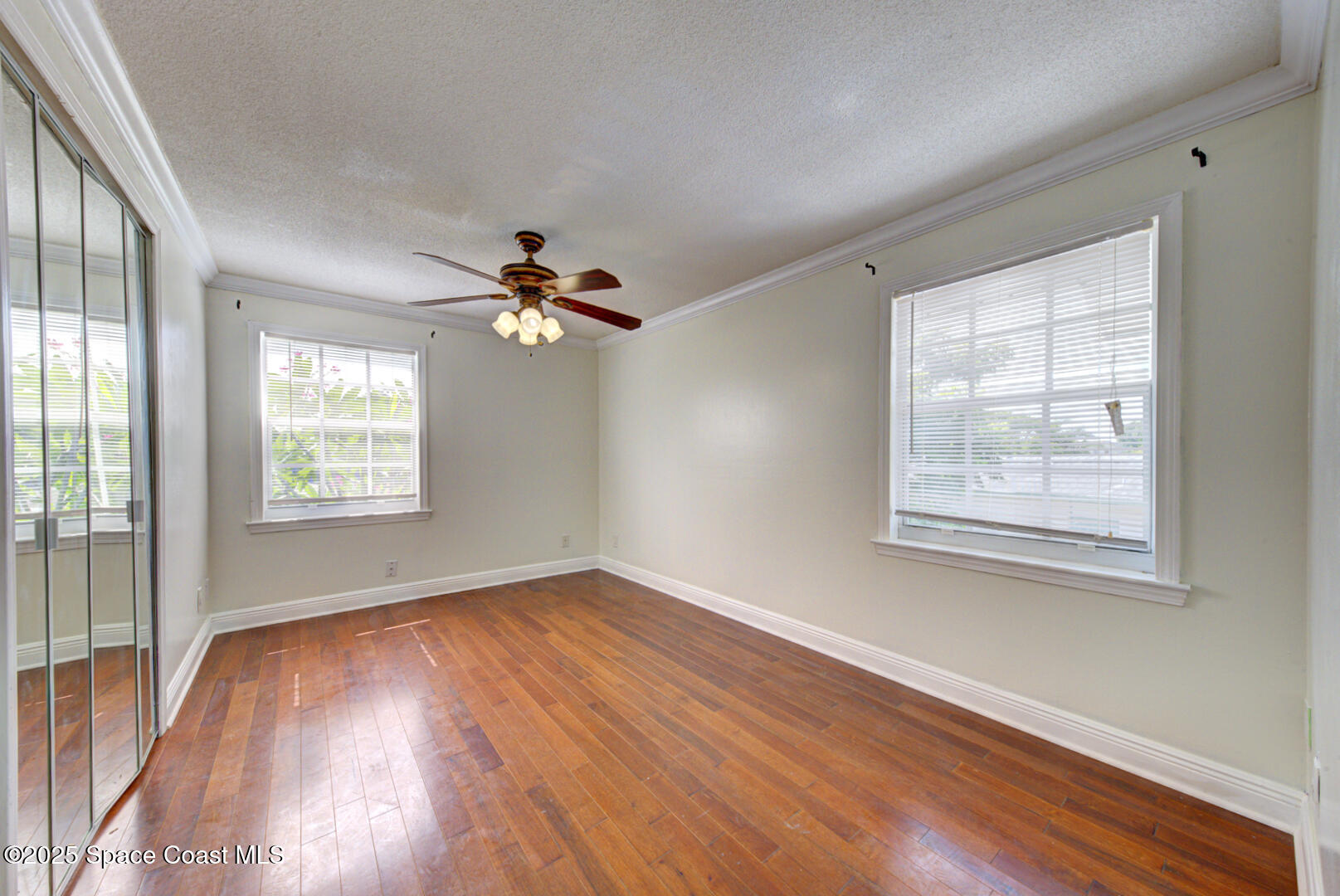 949 Brunswick Lane Rockledge, FL 32955 - Photo 26 of 43 a view of an empty room with wooden floor and a window