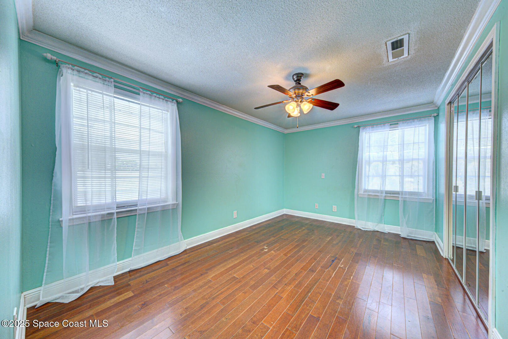 949 Brunswick Lane Rockledge, FL 32955 - Photo 31 of 43 wooden floor in an empty room with a window