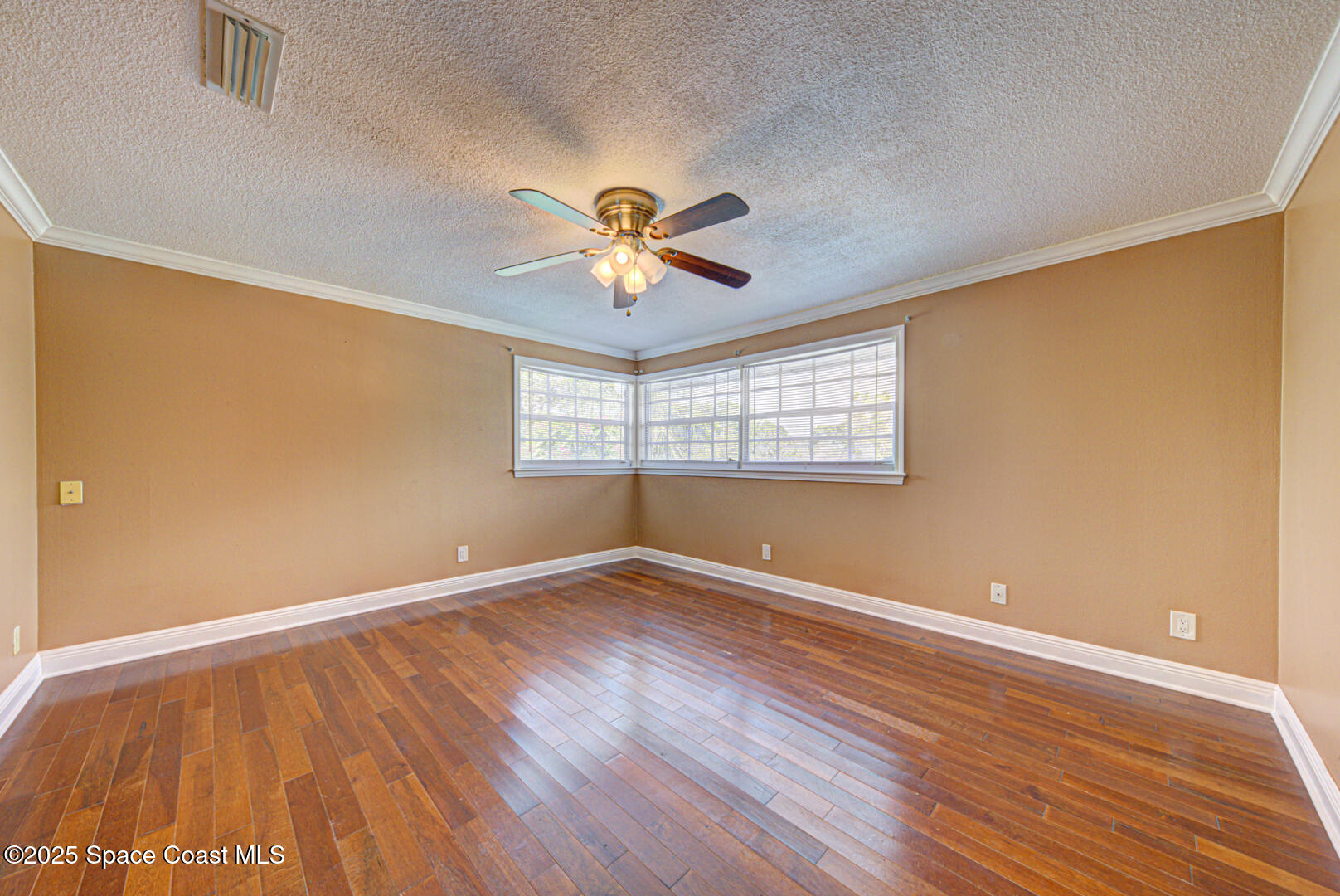 949 Brunswick Lane Rockledge, FL 32955 - Photo 33 of 43 an empty room with wooden floor and windows