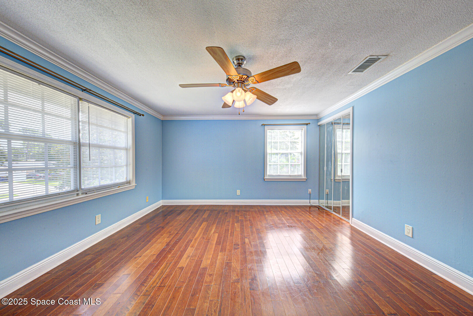 949 Brunswick Lane Rockledge, FL 32955 - Photo 35 of 43 an empty room with wooden floor and windows