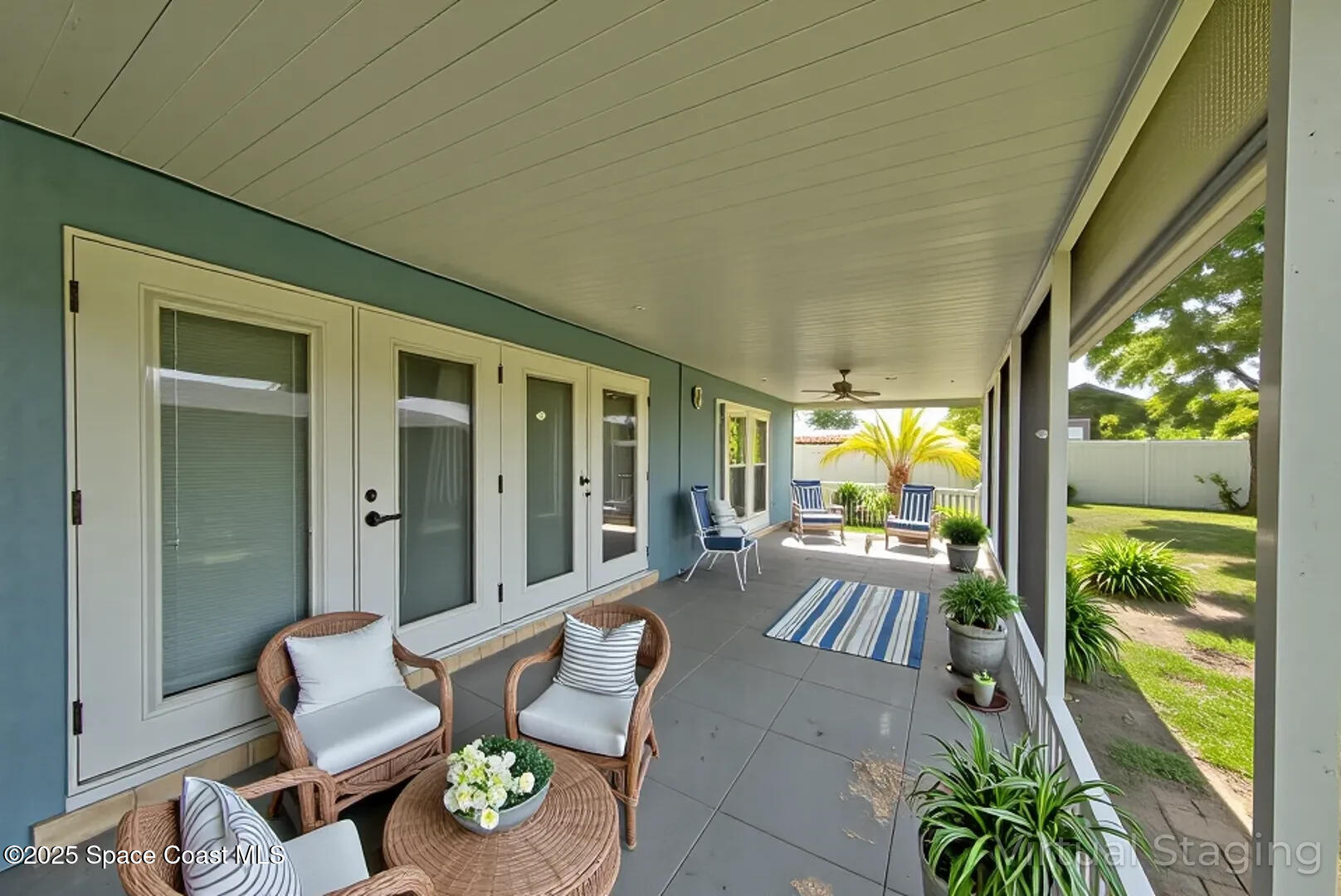 949 Brunswick Lane Rockledge, FL 32955 - Photo 38 of 43 a living room with patio furniture and a floor to ceiling window
