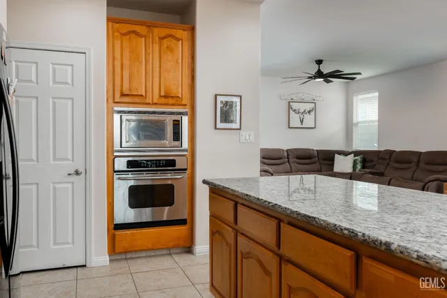 a kitchen with granite countertop a sink stainless steel appliances and cabinets