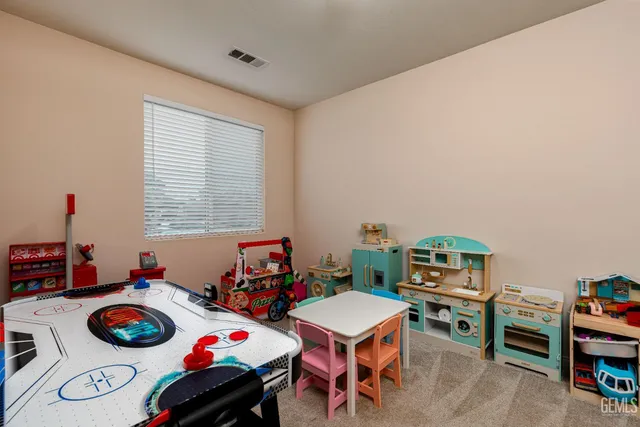 a bedroom with furniture and a book shelf