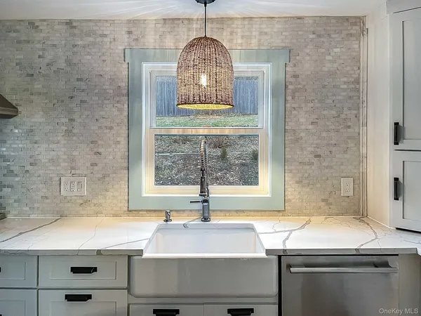 a room with a sink a window and a wooden floor