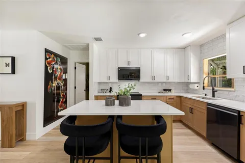 a kitchen with a sink cabinets and stainless steel appliances