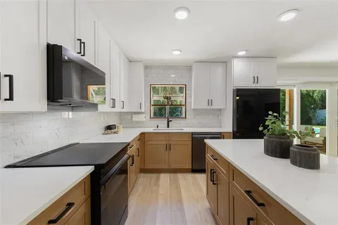 a living room with stainless steel appliances kitchen island granite countertop furniture and a kitchen view
