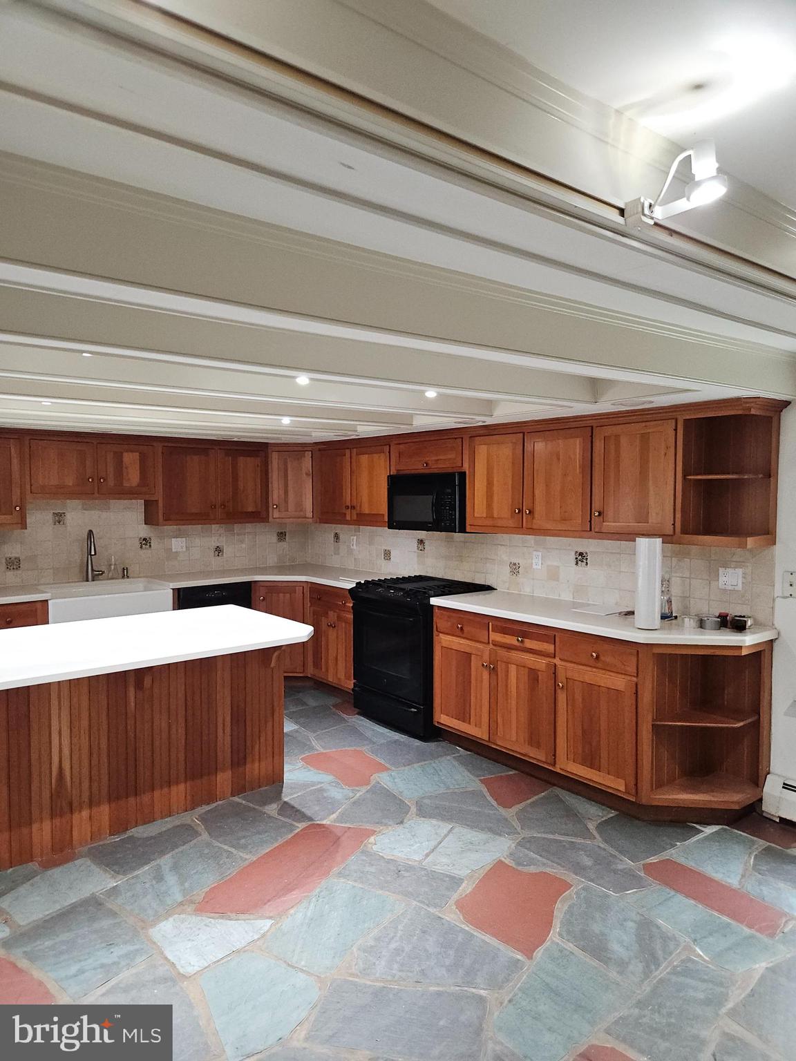 468 Lionville Station Road Chester Springs, PA 19425 - Photo 9 of 26 a large kitchen with stainless steel appliances kitchen island granite countertop a sink counter space and cabinets