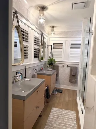 a bathroom with a sink a toilet and shower