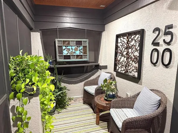 a living room filled with furniture and a potted plant