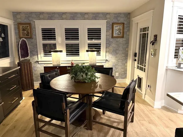 a view of a dining room with furniture and window