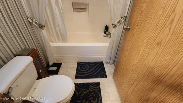 a bathroom with a toilet a sink and a bathtub