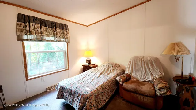 a bedroom with bed and a window