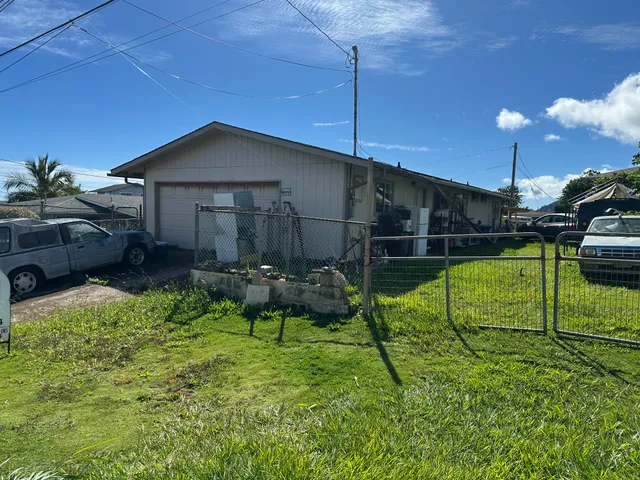 a view of house with backyard and patio