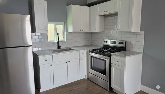 a kitchen with white cabinets and white appliances