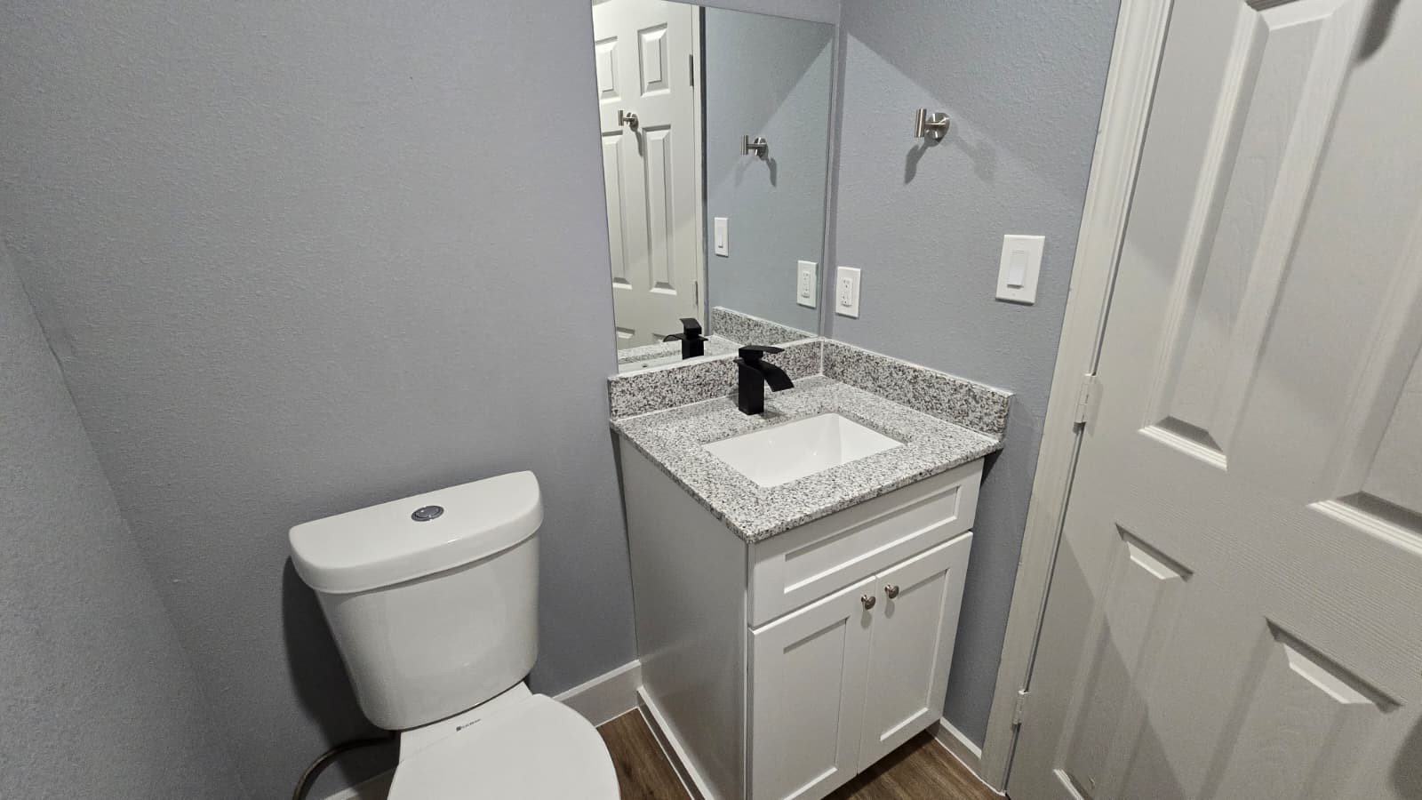 1012 Ann, Unit H Pasadena, TX 77506 - Photo 6 of 6 a bathroom with a granite countertop toilet sink and mirror