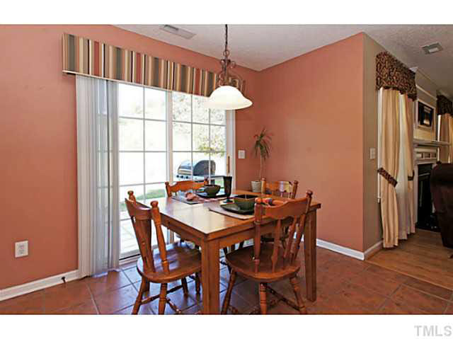 2217 Woodwyck Way Raleigh, NC 27604 - Photo 11 of 25 a view of a dining room with furniture and wooden floor