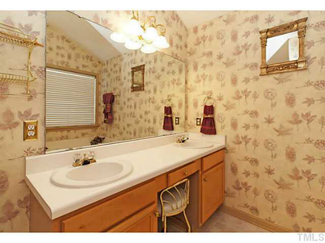 2217 Woodwyck Way Raleigh, NC 27604 - Photo 16 of 25 a bathroom with a sink and a mirror