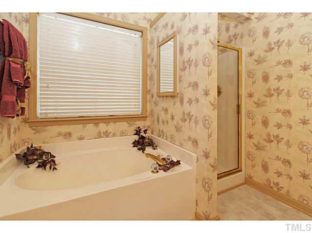 2217 Woodwyck Way Raleigh, NC 27604 - Photo 17 of 25 a bathroom with a bathtub and a shower