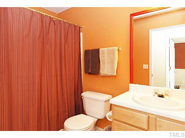 2217 Woodwyck Way Raleigh, NC 27604 - Photo 19 of 25 a bathroom with a sink a toilet and shower