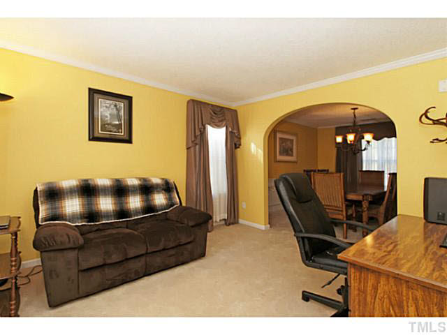 2217 Woodwyck Way Raleigh, NC 27604 - Photo 4 of 25 a living room with a furniture and a flat screen tv