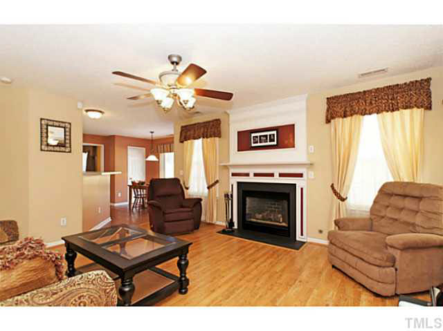 2217 Woodwyck Way Raleigh, NC 27604 - Photo 7 of 25 a living room with furniture a fireplace and a large window