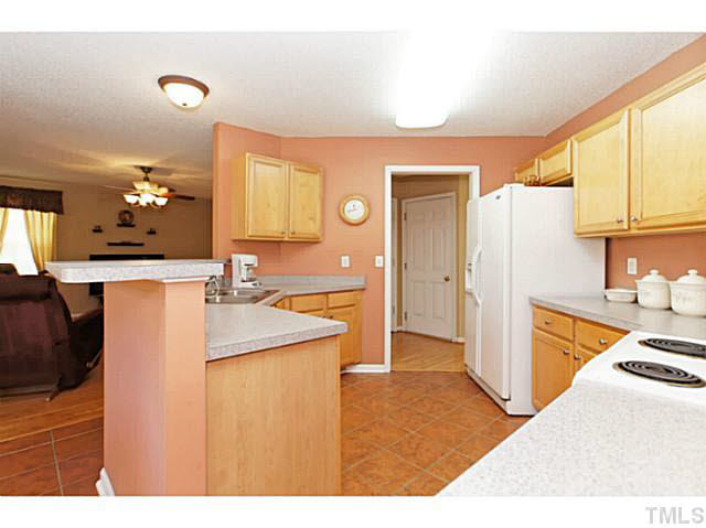 2217 Woodwyck Way Raleigh, NC 27604 - Photo 8 of 25 a kitchen with a sink refrigerator and cabinets