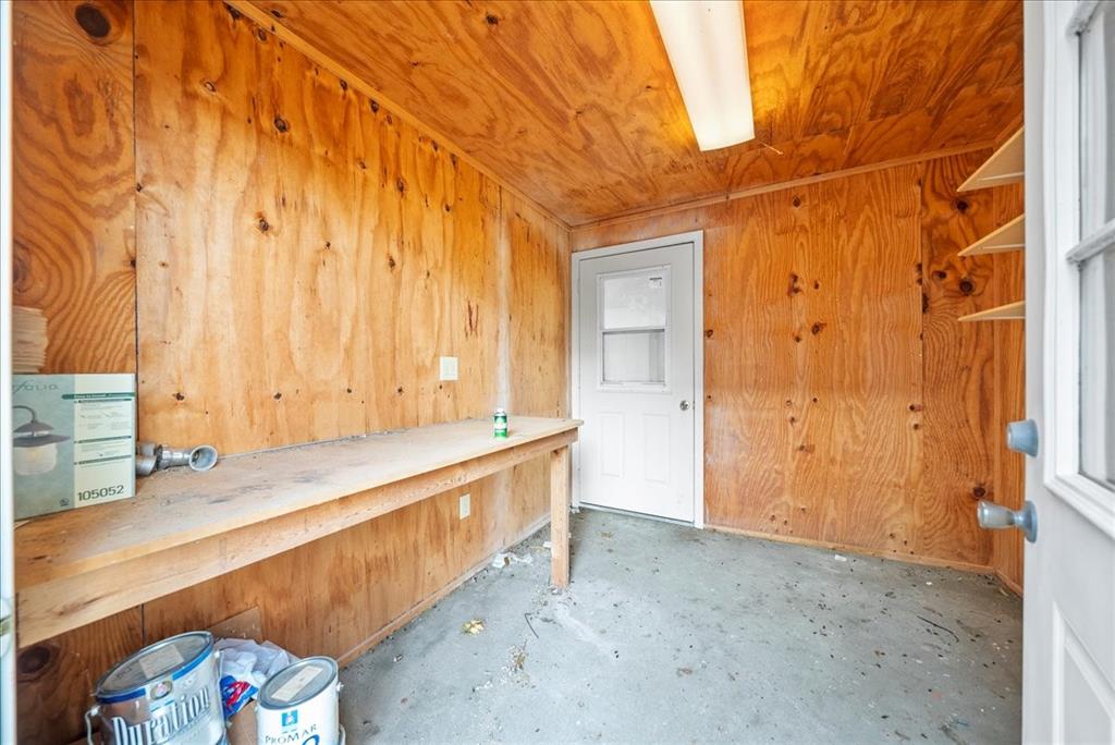 101 North 7th Street Krum, TX 76249 - Photo 20 of 26 Misc room with wood walls, unfinished concrete flooring, and wood ceiling