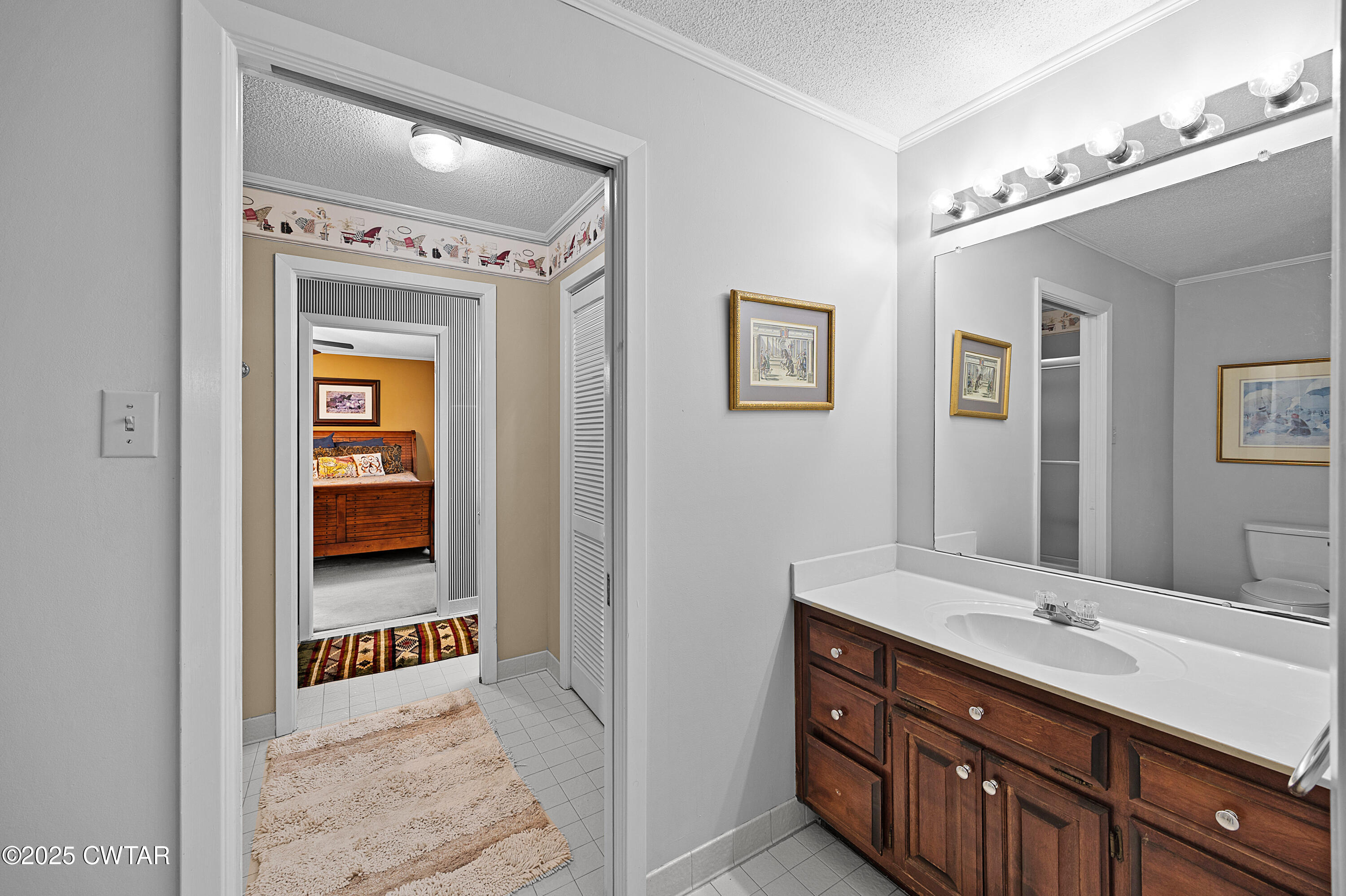 1882 Sand Ridge Bargerton Road Lexington, TN 38351 - Photo 18 of 34 a en suite bathroom with a double vanity sink and a mirror