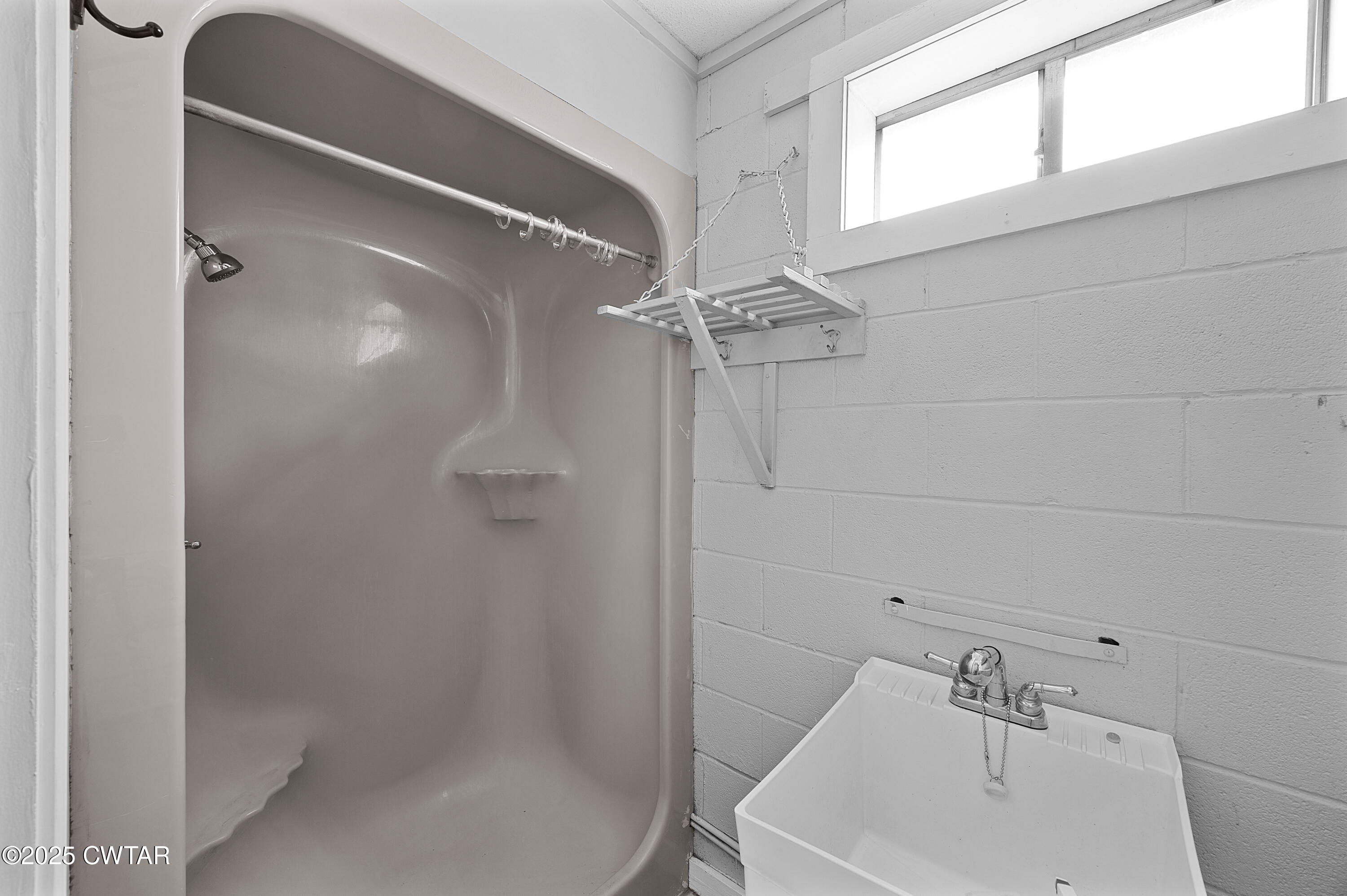 1882 Sand Ridge Bargerton Road Lexington, TN 38351 - Photo 23 of 34 a bathroom with a sink a window and shower