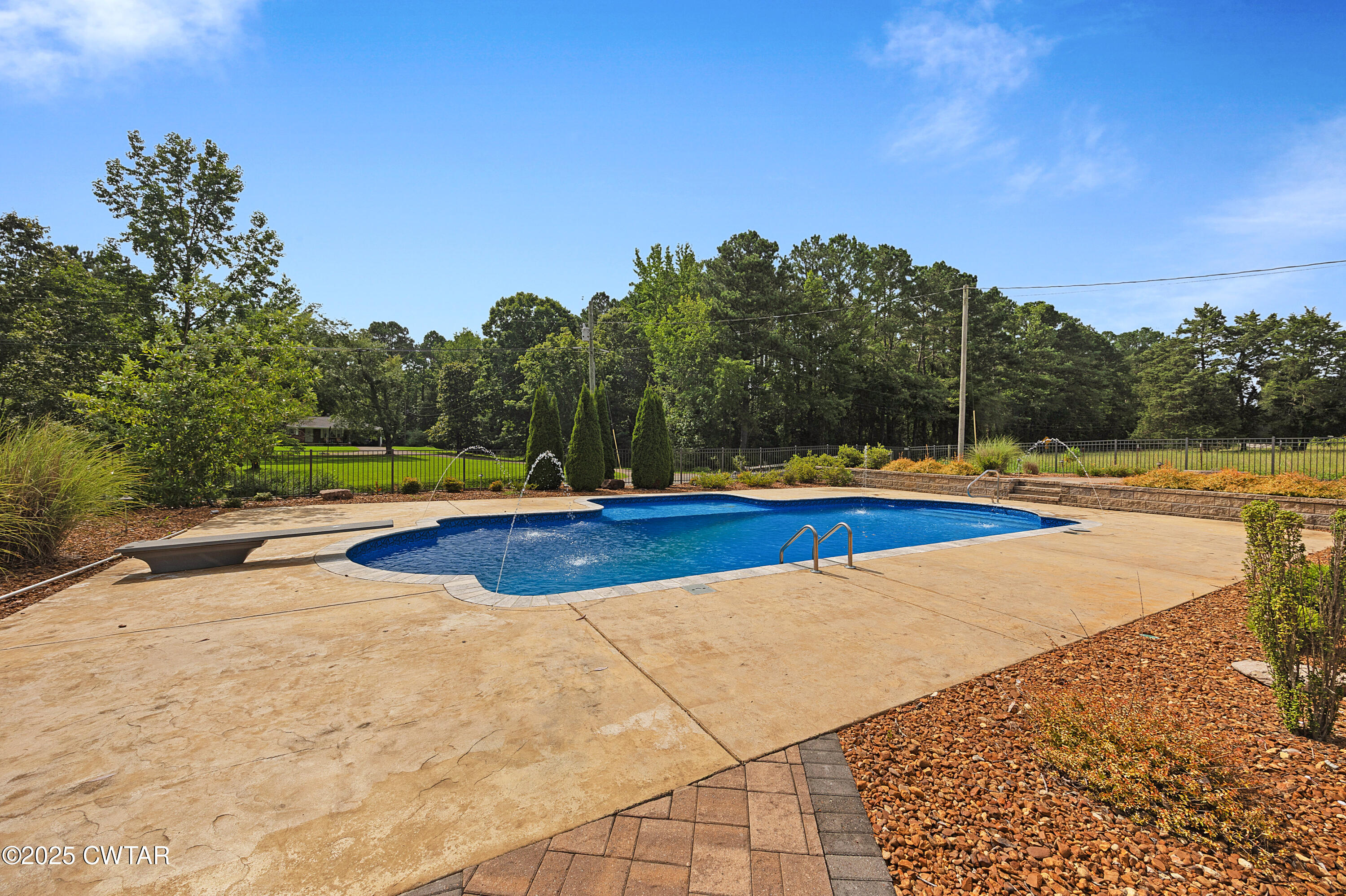 1882 Sand Ridge Bargerton Road Lexington, TN 38351 - Photo 25 of 34 a view of a swimming pool with an outdoor space and seating area