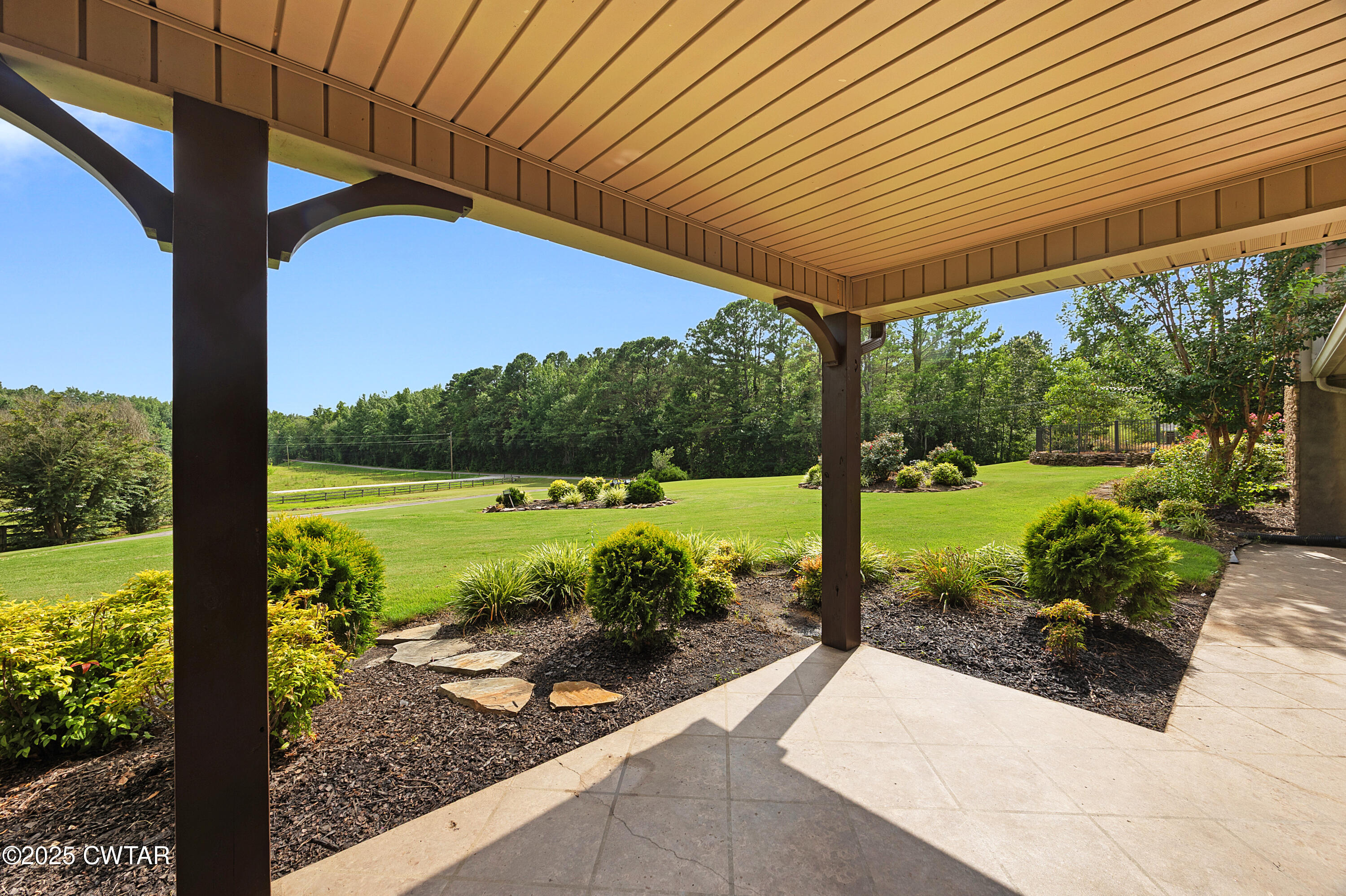 1882 Sand Ridge Bargerton Road Lexington, TN 38351 - Photo 5 of 34 a view of a patio with a table chairs and a table