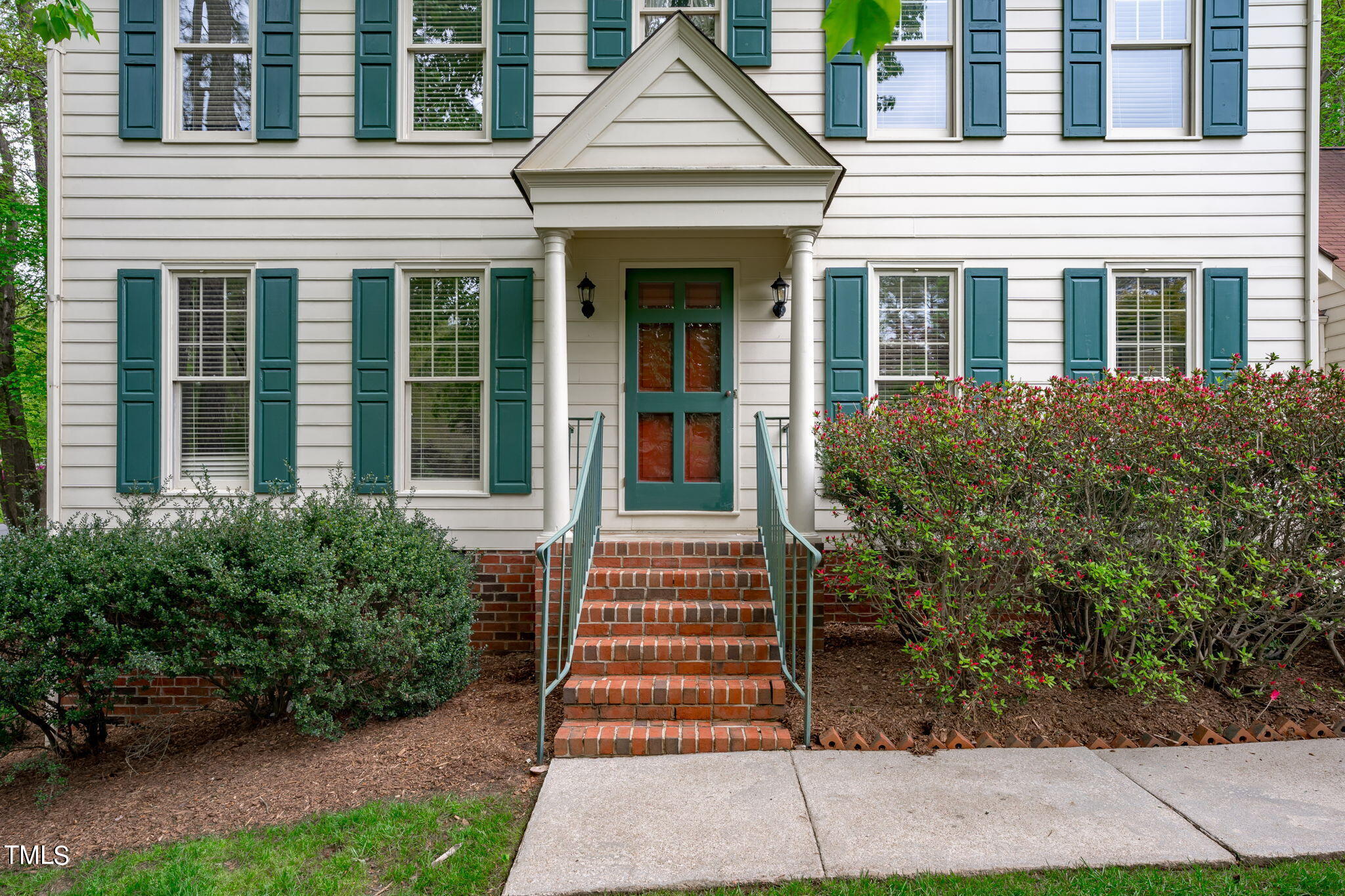8808 Bickley Place Raleigh, NC 27613 - Photo 3 of 43 a front view of a house with a yard