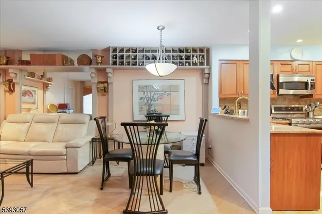 a living room with furniture a chandelier and a dining table