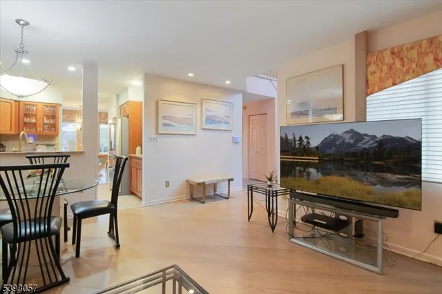 a kitchen with stainless steel appliances kitchen island granite countertop a table and chairs