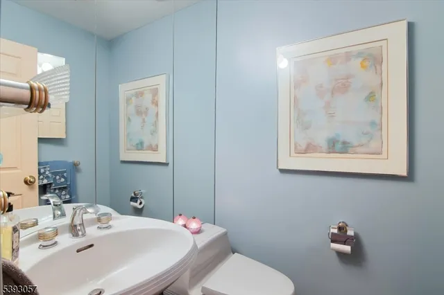 a bathroom with a sink mirror and toilet