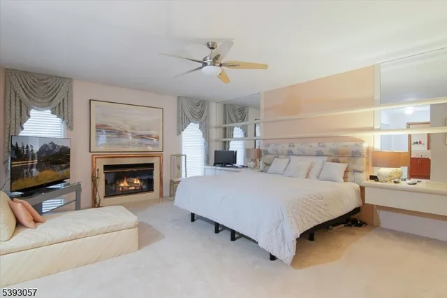 a spacious bedroom with a large bed and a fireplace