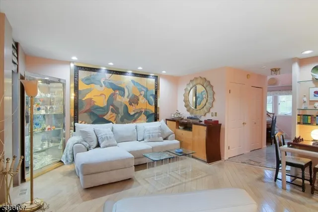 a living room with furniture and a clock