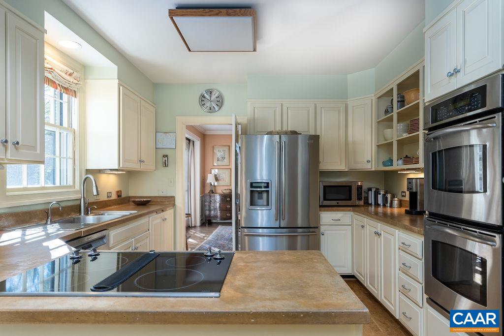 35 Old Farm Road Charlottesville, VA 22903 - Photo 18 of 44 a kitchen with stainless steel appliances granite countertop a refrigerator a stove and a sink with wooden cabinets